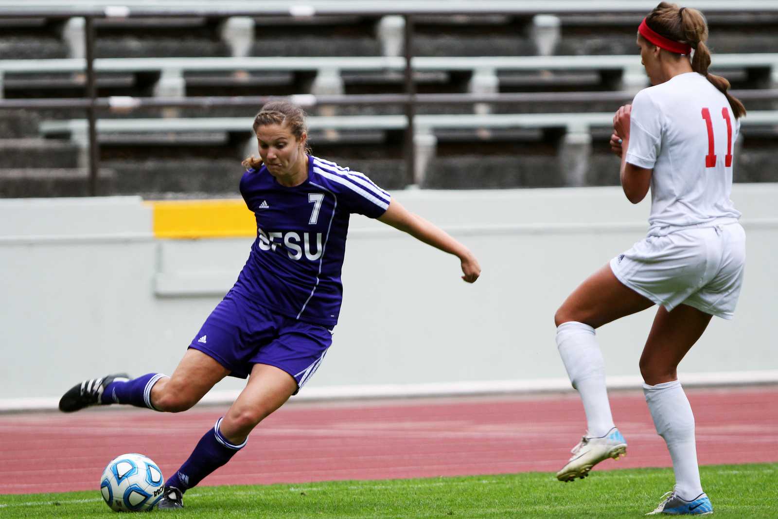 Mari Mendizabal (7) kicks the ball past Rachel Crawford(11) during a game featuring the SF State Gators vs the Western Oregon University Wolves at Cox Stadium on September 11, 2013. The Gators tied the Wolves in the second half of the game, the final score was 1-1. Photo by Gavin McIntyre / Xpress