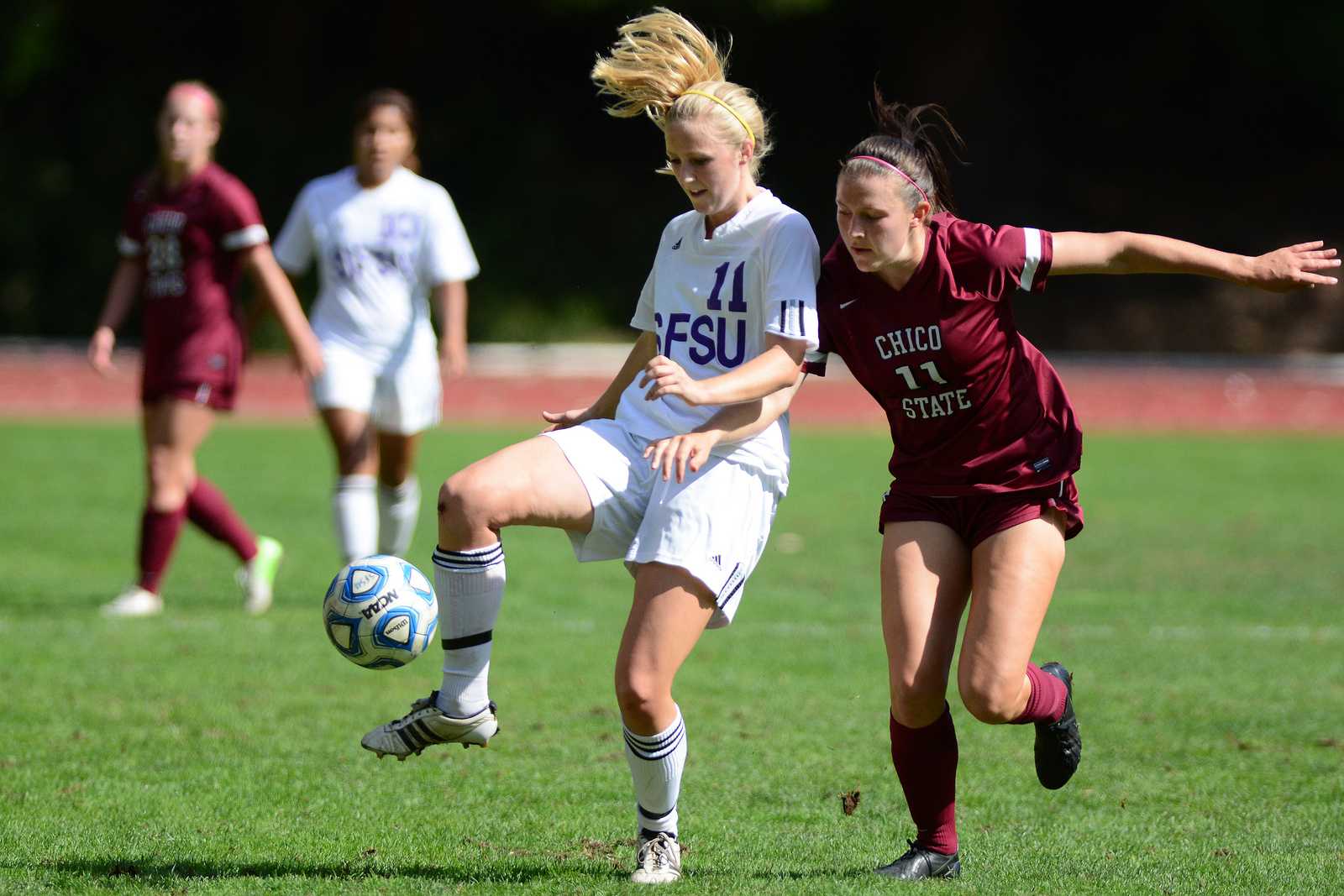 SF State's Julie Haselton (11) fights off Gail Bassett (11) for control of the ball during a game against Chico State at Cox Stadium, Oct. 6, 2013. The Gators won the game 1-0. Photo by Philip Houston / Xpress