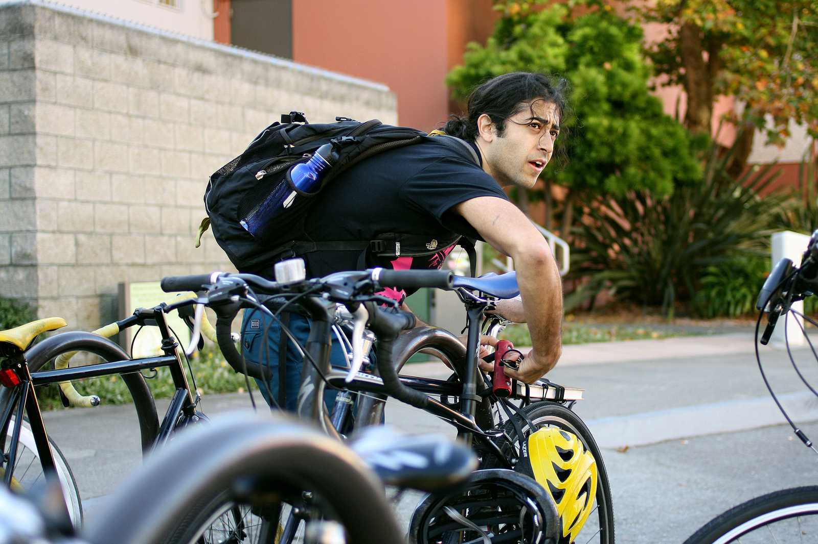Shervin Sahba locks up his bike between Humanities and Creative Arts buildings Oct. 7, 2013. Photo by Tony Santos / Xpress