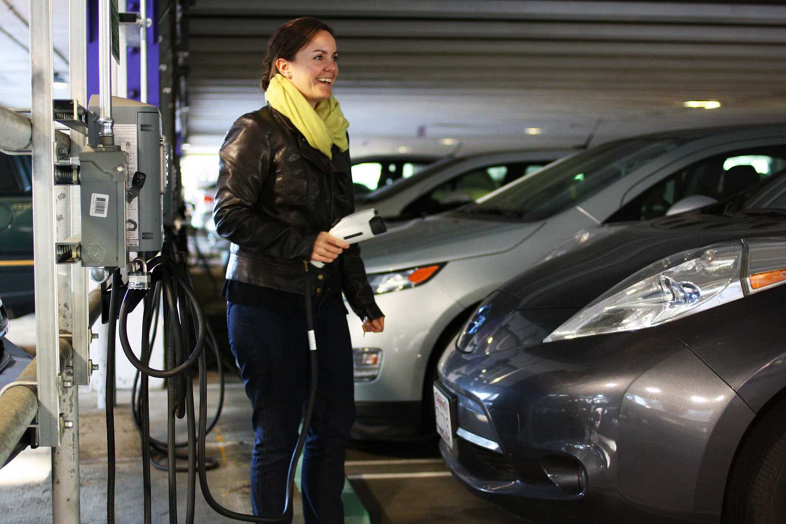 Kinesiology professor Marcia Abbott unplugs her car from the free electric charging stations on the first floor of the parking lot, located near the elevator Oct. 10, 2013. Photo By Tony Santos / Xpress