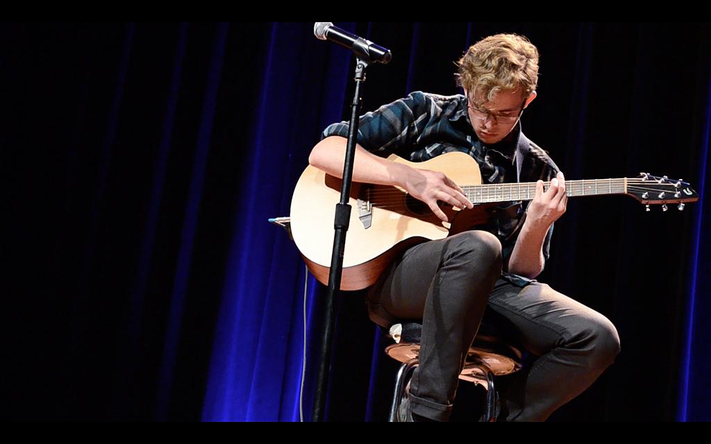 Sean Thompson plays guitar during The Voice competition at SF State, Oct. 23, 2013. Photo by Shawn Whelchel / Xpress