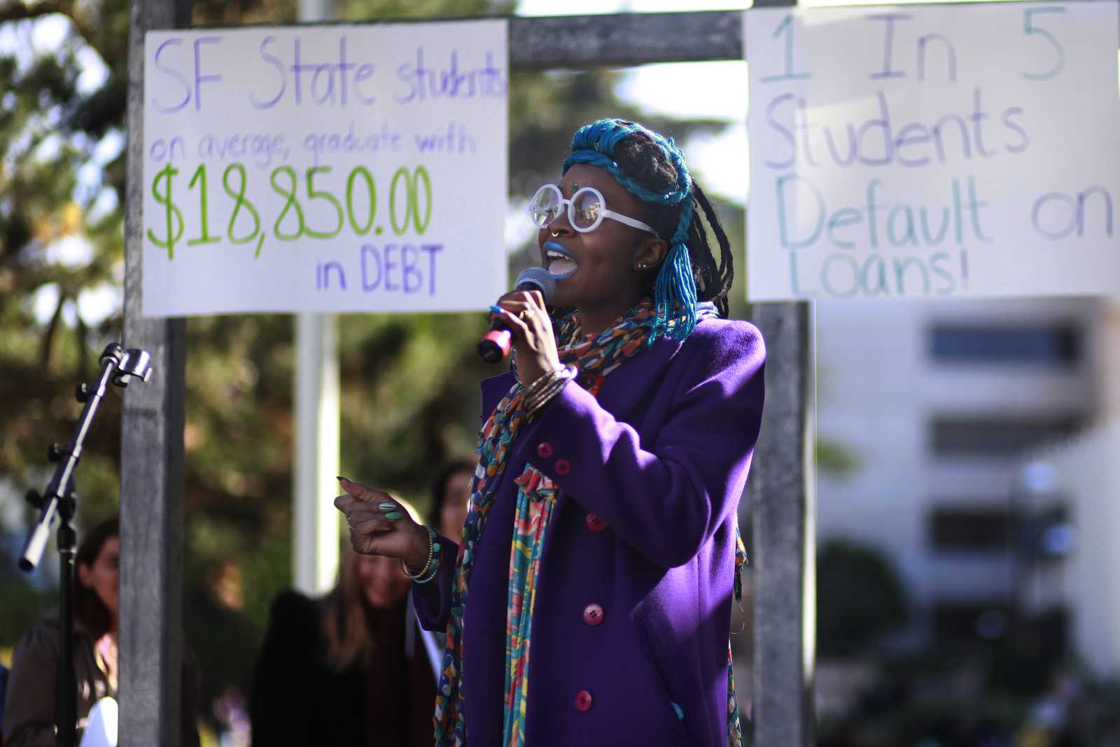 Telisa Nyoka, a recent ethnic studies graduate and TA, sings during the equity week rally at SF State in Malcolm X Plaza, Oct. 28, 2013. Her song related to the high cost of tuition and student debt. Photo by Mike Hendrickson / Xpress