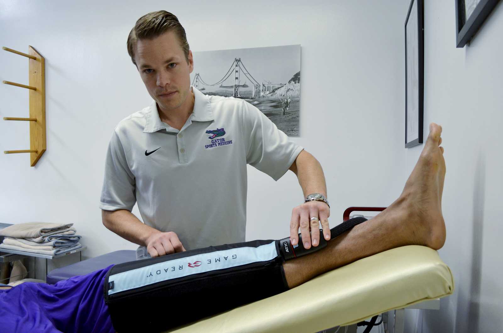 Bryce Schussel, the head athletic trainer at SF State since June 2009, works with SF State men's basketball player Eric Fearn in the training room in the Gymnasium building Friday, Nov. 15, 2013. Photo by Amanda Peterson / Xpress