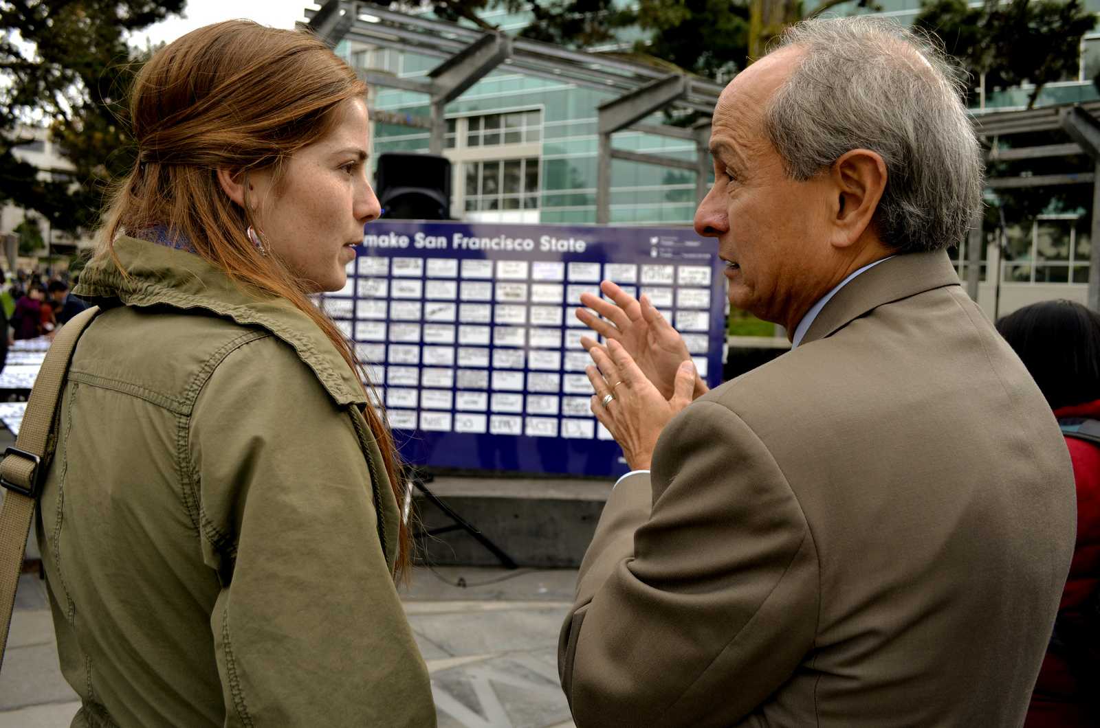 Kaitlyn Cornell (left) a 21-year-old drama and political science major, talks with President Leslie E. Wong in Malcolm X Plaza during the Strategic Plan event Monday, Nov. 18, 2013. Students expressed their ideas and shared what they thought would make SF State a better place. Photo by Amanda Peterson / Xpress