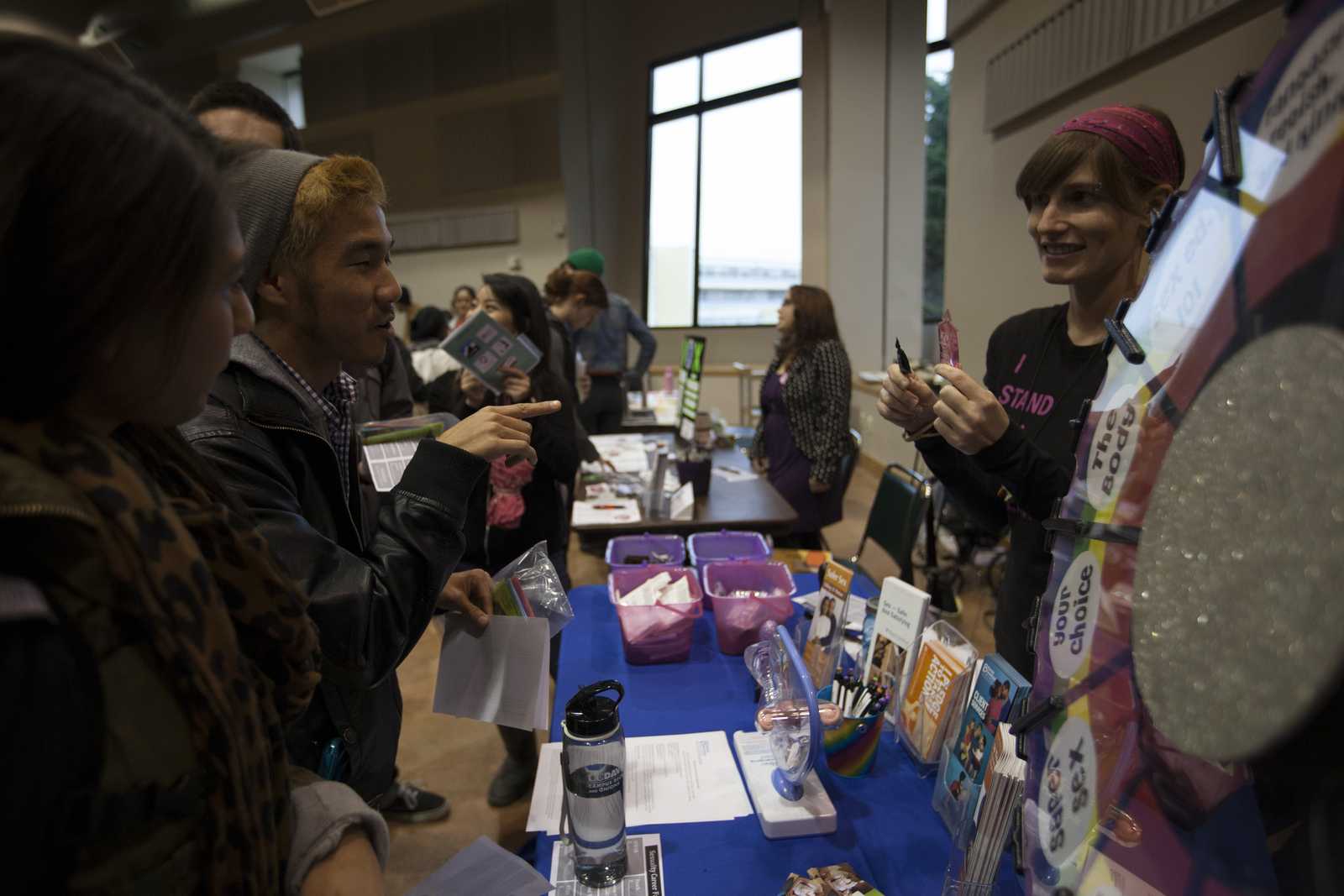 Josselyn Garcia (left) and Russell Lim (right) play a game with Planned Parenthood representative, Eb Troast (right), at the 5th annual Sexuality Career Fair on Nov. 19, 2013. The fair, held at SF State's Jack Adams Hall, was hosted by Educational and Referral Organization for Sexuality, or EROS. Photo by Dariel Medina / Xpress