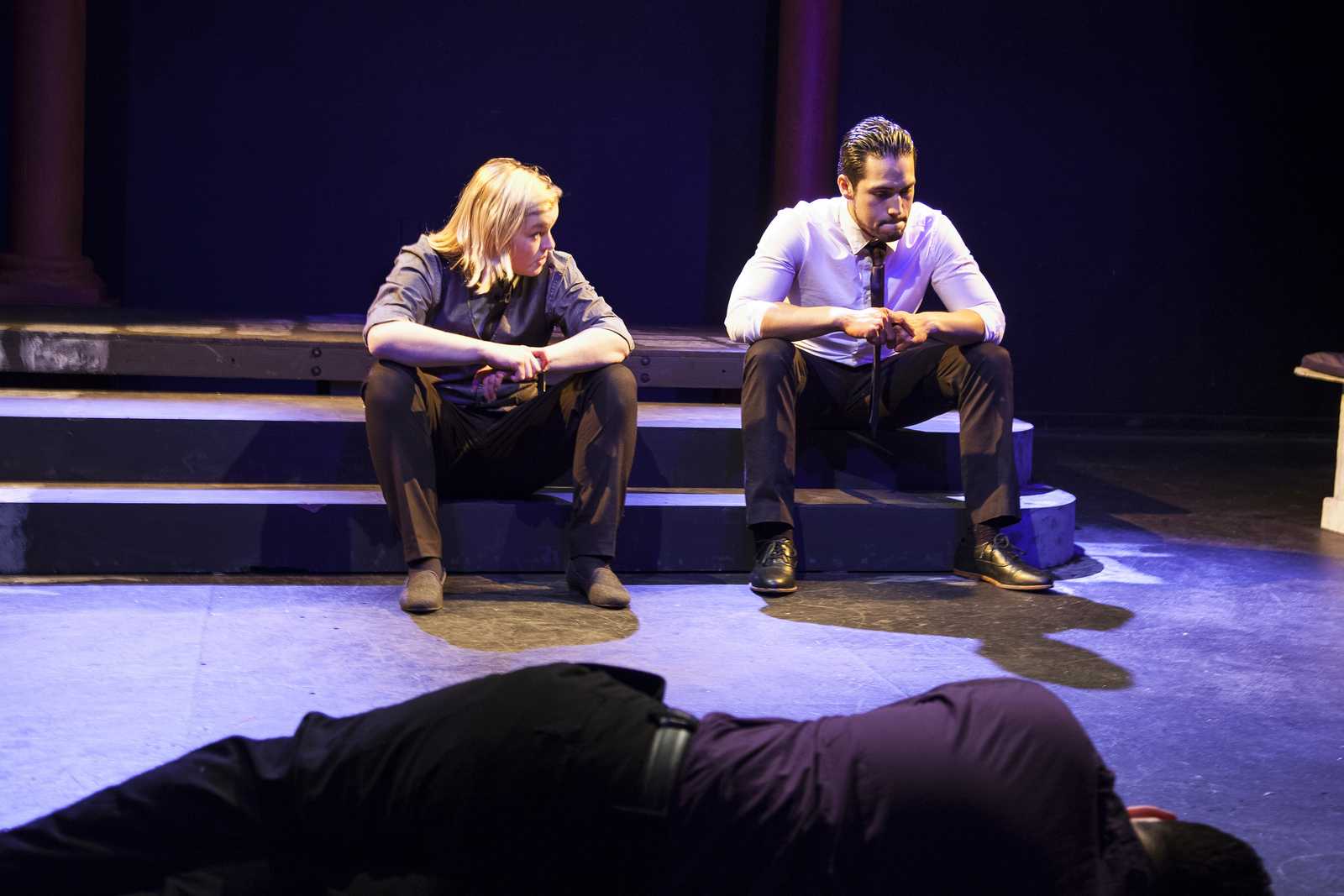 Theater majors Lo Prentiss as Cassius and Jonathan Schulz as Brutus in a scene from this semester's Brown Bag Theatre's abbreviated version of Julius Cesar. Kyle McReddie, lying on the floor, plays the dead Julius Cesar. Photo by Ayesha Rizvi / Xpress